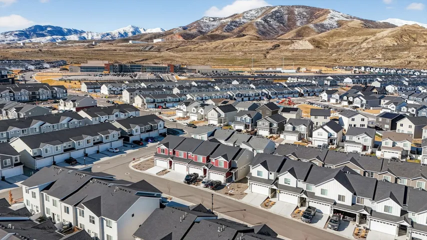 Aerial view of residential area featuring a mountain backdrop