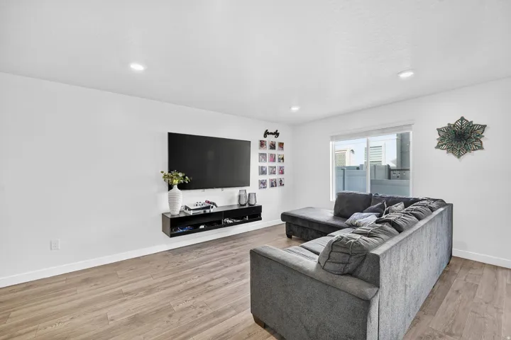 Living room featuring light wood-style flooring and recessed lighting