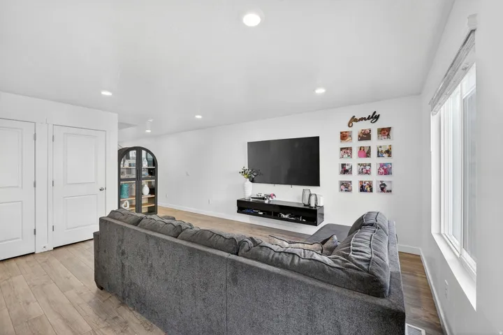 Living room featuring light wood-style flooring and recessed lighting