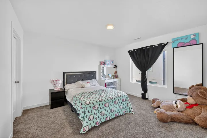 Carpeted bedroom featuring baseboards