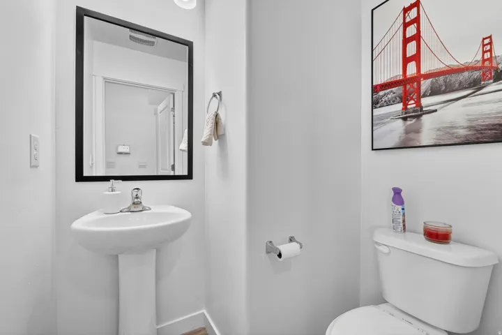 Half bath featuring toilet and baseboards