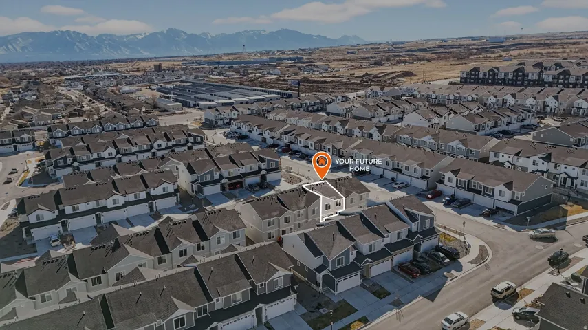Aerial view of property's location with a mountain backdrop and nearby suburban area