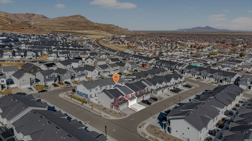 Aerial view of property's location featuring a mountainous background and nearby suburban area