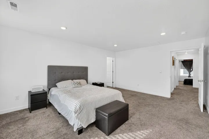 Carpeted bedroom featuring baseboards and recessed lighting