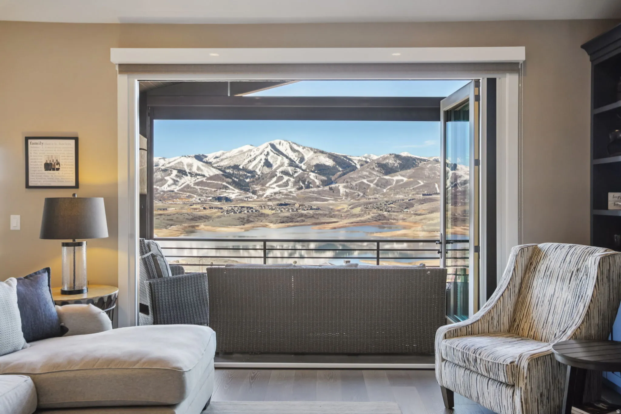 Living area with a water and mountain view and wood finished floors