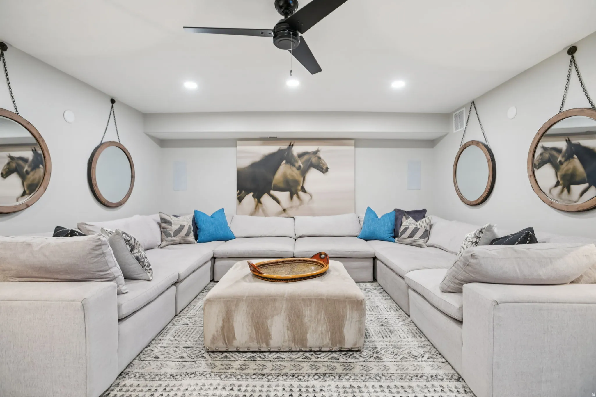 Living area with recessed lighting and ceiling fan