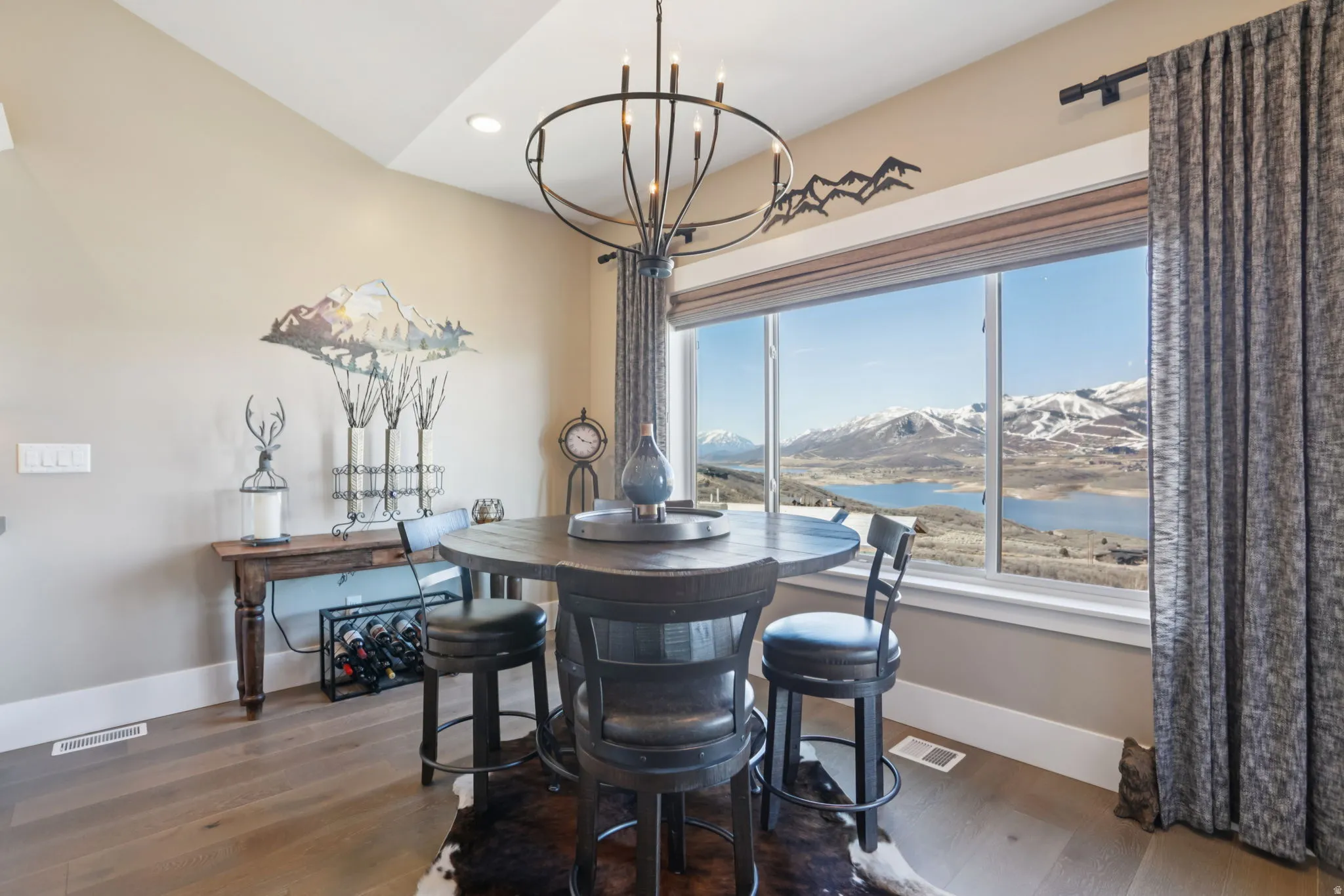 Dining room featuring a mountain view, a chandelier, and dark wood-style flooring
