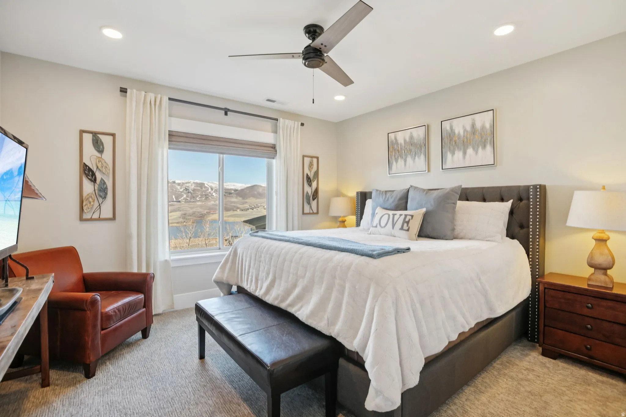 Bedroom with a mountain view, light colored carpet, ceiling fan, and recessed lighting