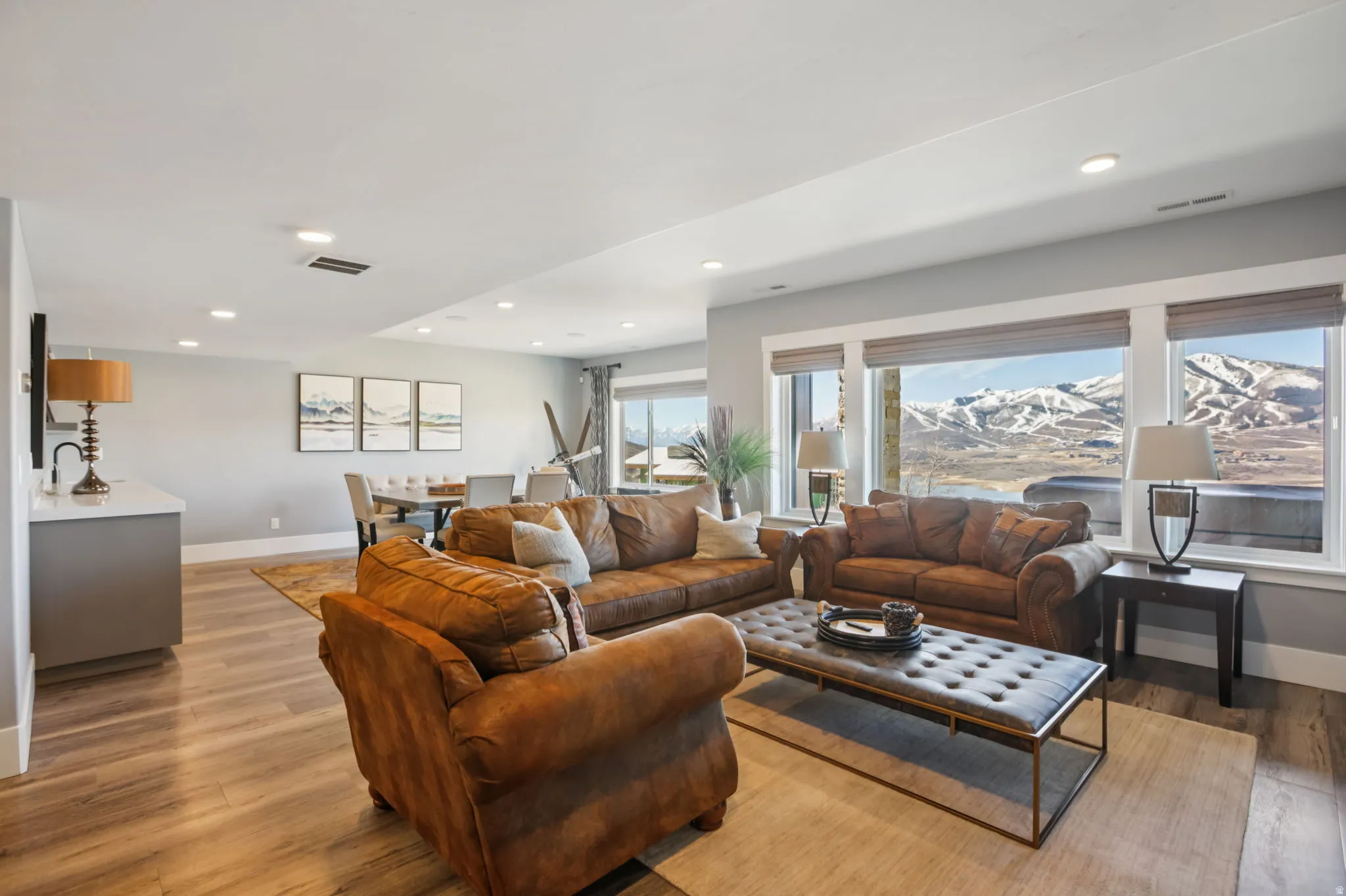 Living area with light wood-style floors, a mountain view, and recessed lighting