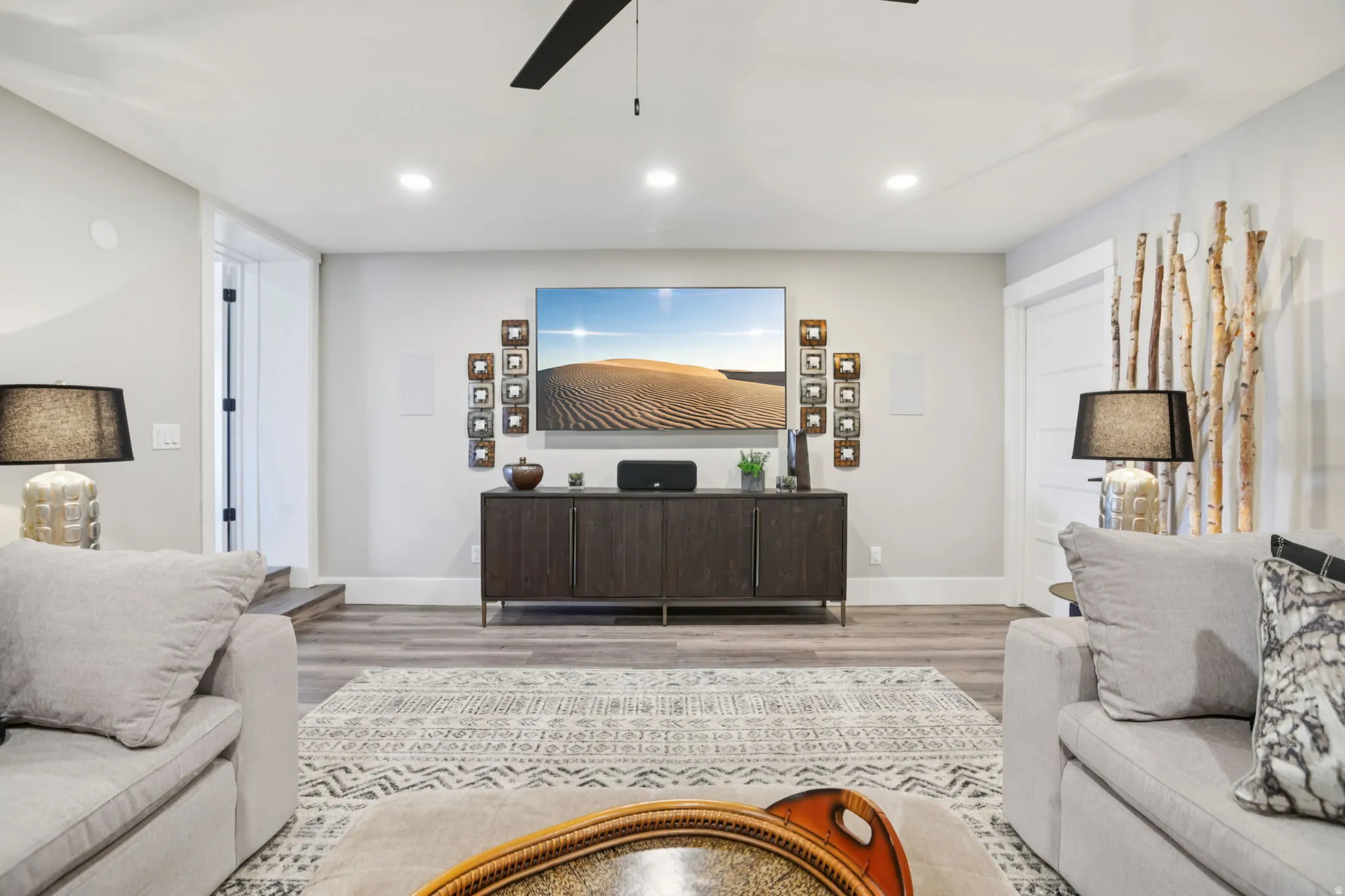 Living room featuring light wood-style flooring, a ceiling fan, and recessed lighting