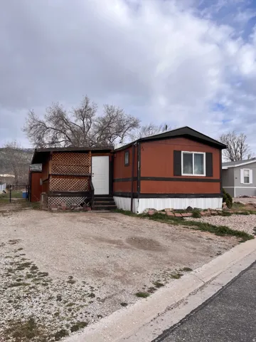 View of property exterior featuring entry steps and driveway