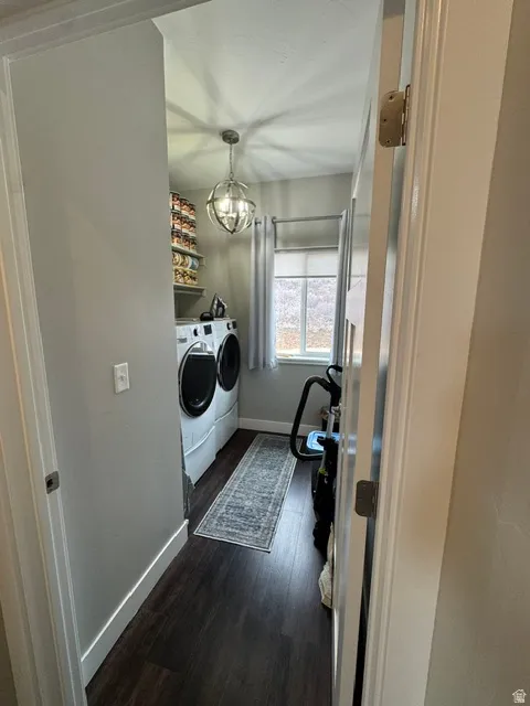 Laundry room with dark wood-style flooring and washer and dryer