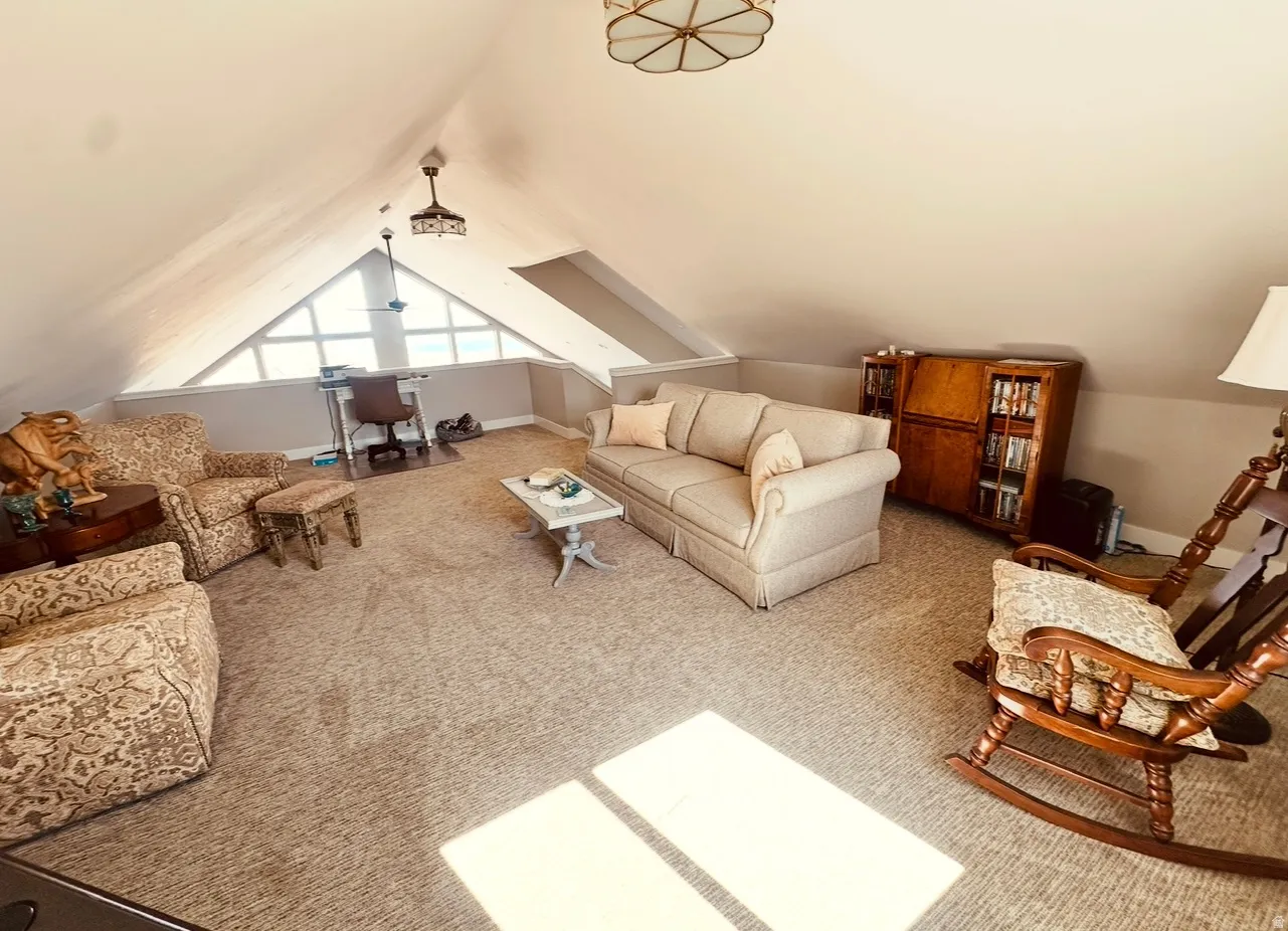 Carpeted living area featuring baseboards