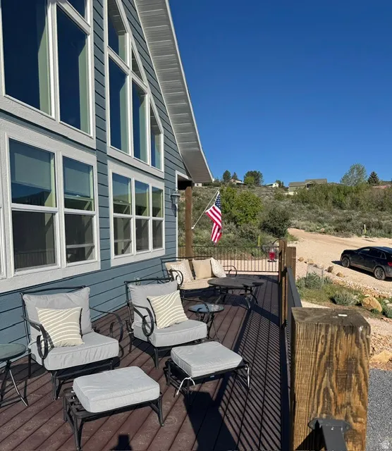 Expansive exterior deck featuring composite decking and black metal railings