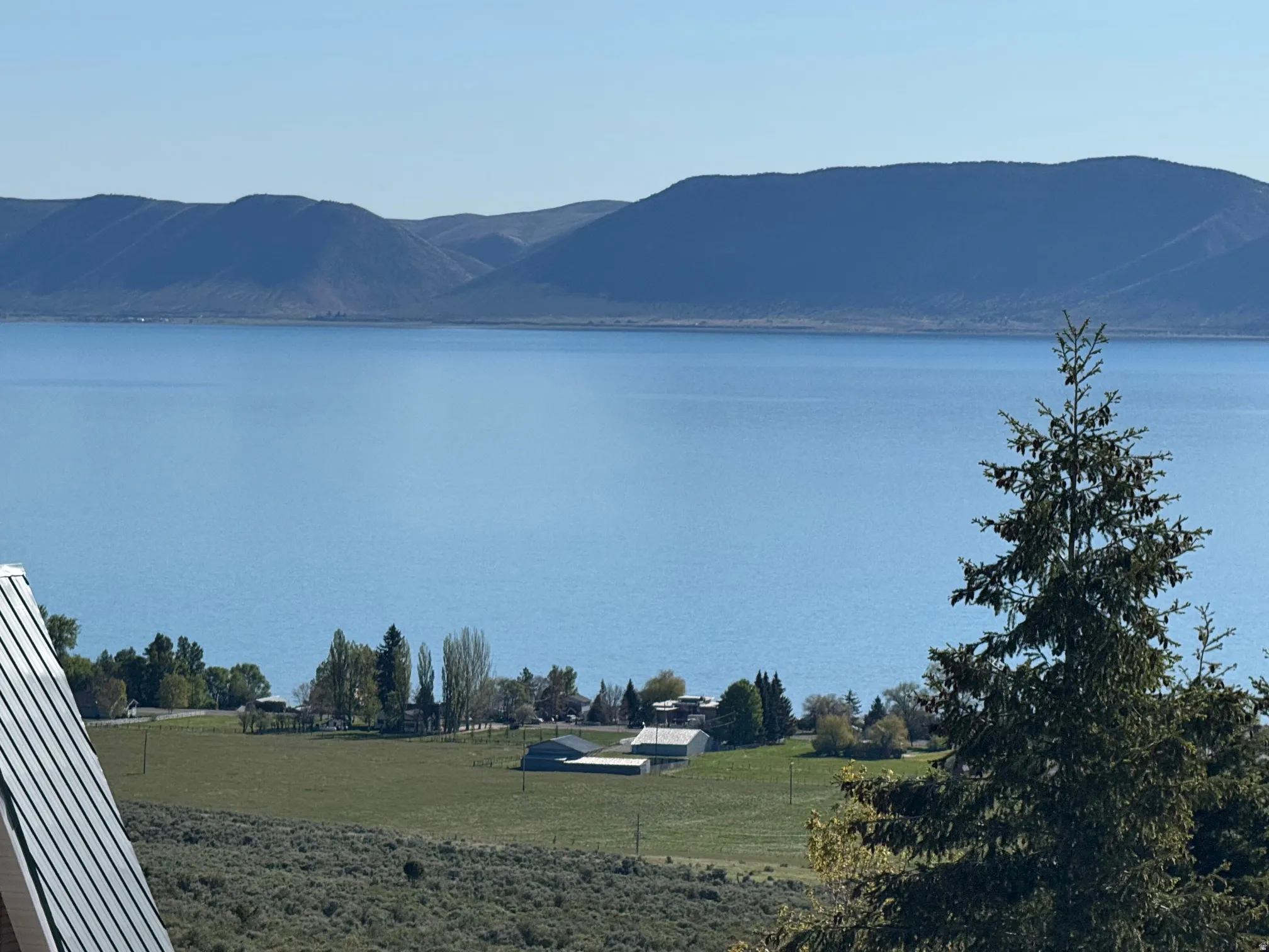 Expansive water frontage with mountain backdrop