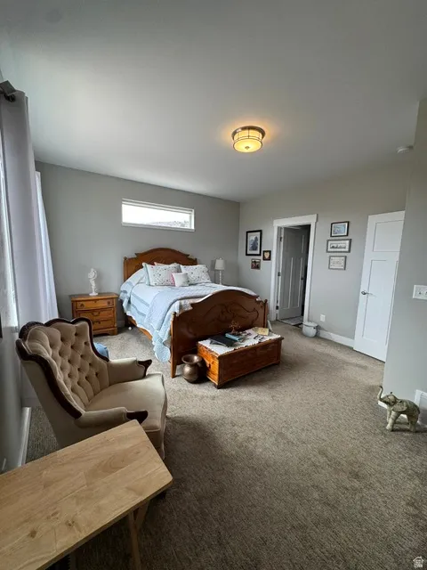 Carpeted bedroom featuring baseboards