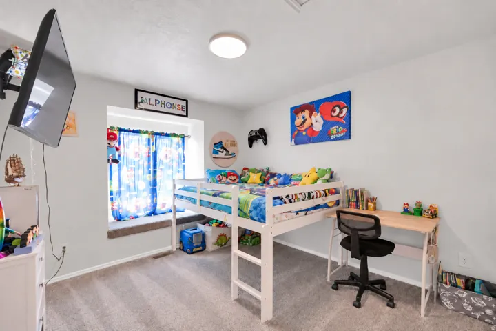 Carpeted flooring, window with sill, flush mount ceiling light, and built-in wall niche