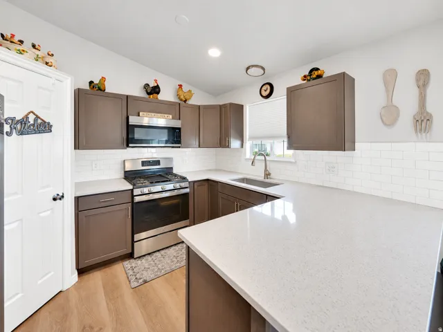 U-shaped kitchen with wood-finish cabinetry and light-toned countertops