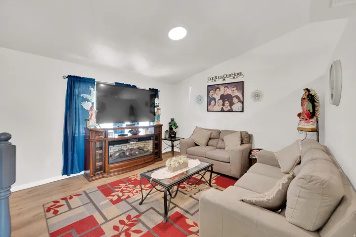 Living area featuring light wood-style flooring and vaulted ceiling