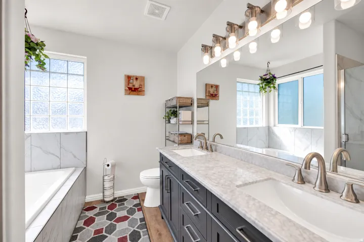 Dual vanity with undermount sinks, stone countertops, and brushed nickel fixtures