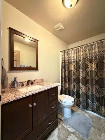 Bathroom with vanity and curtained shower