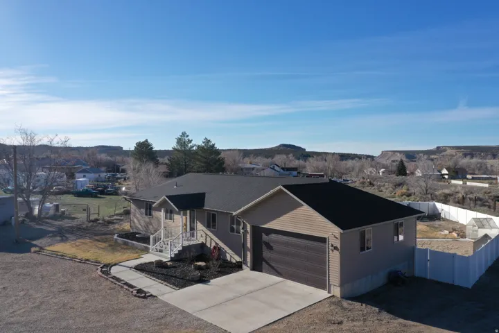 Ranch-style house with concrete driveway and an attached garage