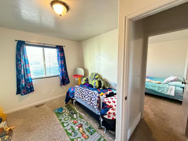 Carpeted bedroom featuring baseboards