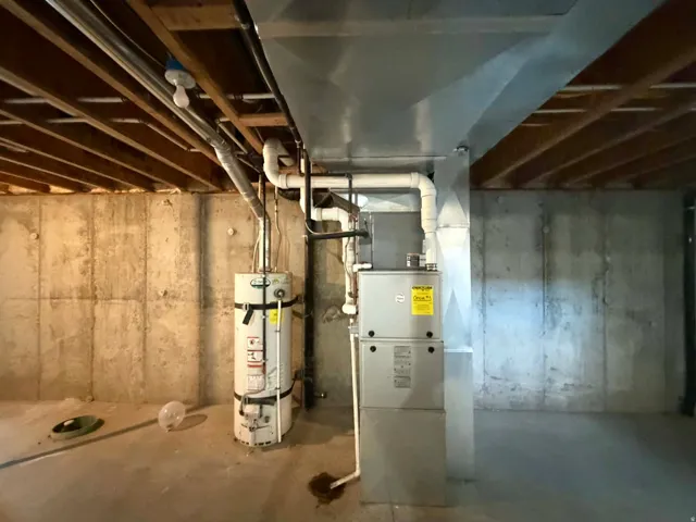 Unfinished basement with strapped water heater