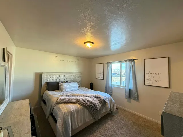 Bedroom with carpet flooring and a textured ceiling