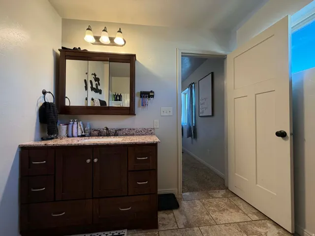 Bathroom with vanity and baseboards