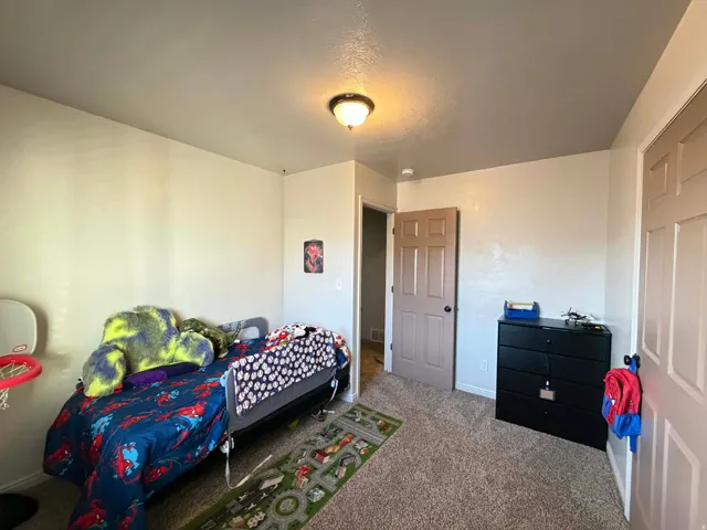 Carpeted bedroom featuring baseboards