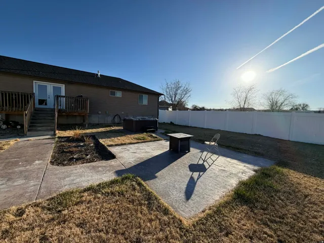 Fenced backyard with a patio area and a deck