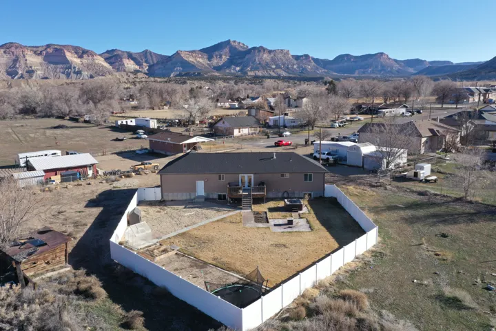 Aerial perspective of suburban area featuring a mountainous background