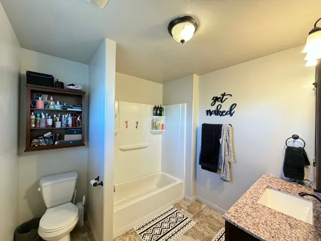 Bathroom featuring vanity and  shower combination