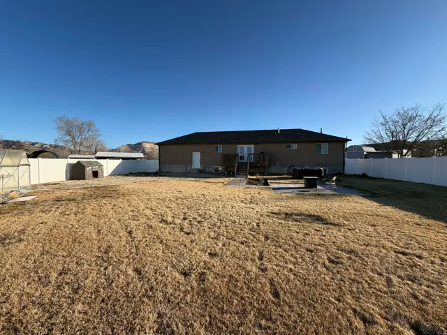 Rear view of property featuring a patio area,  and a fenced backyard.