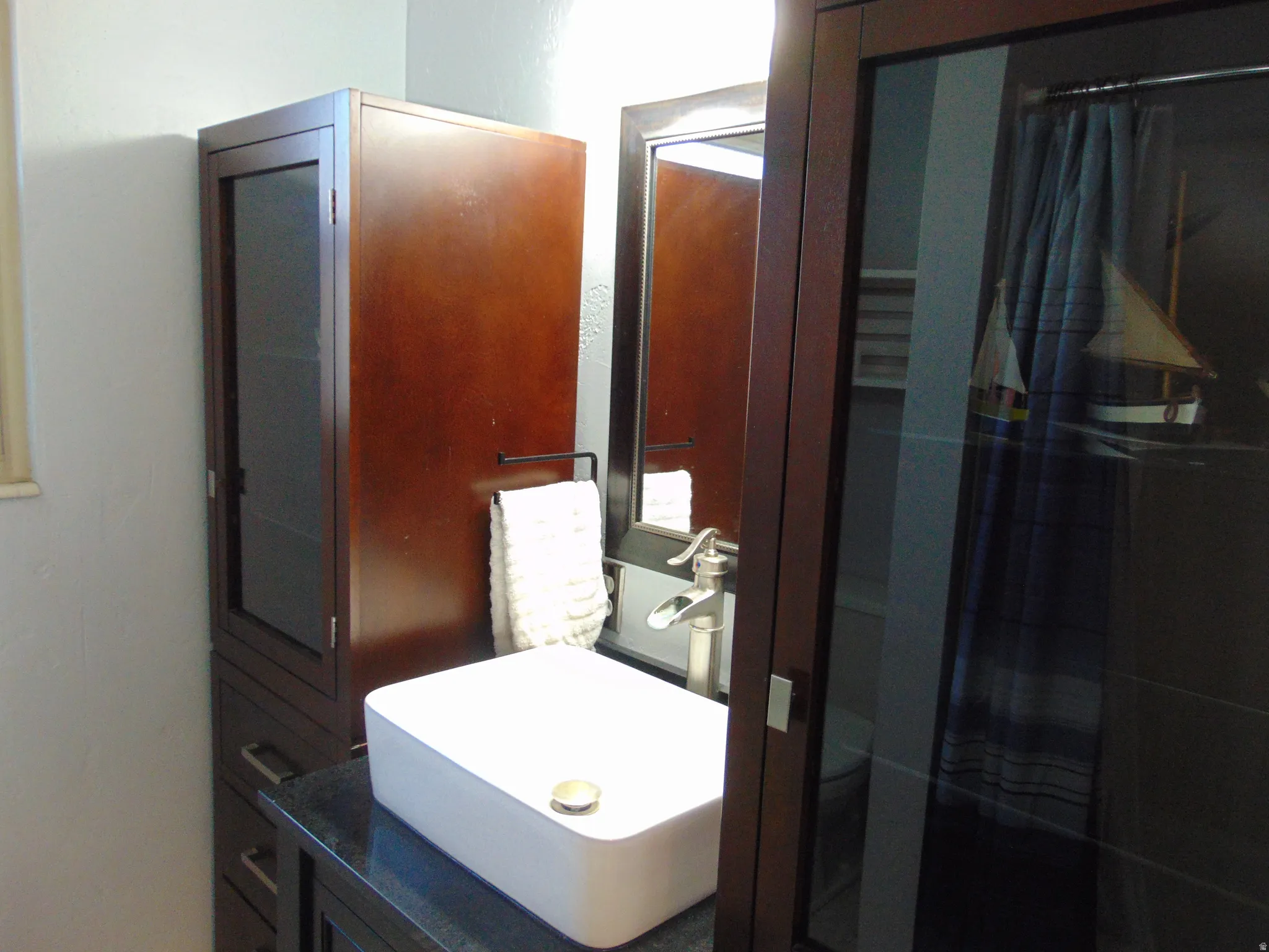 Bathroom featuring a shower stall and vanity
