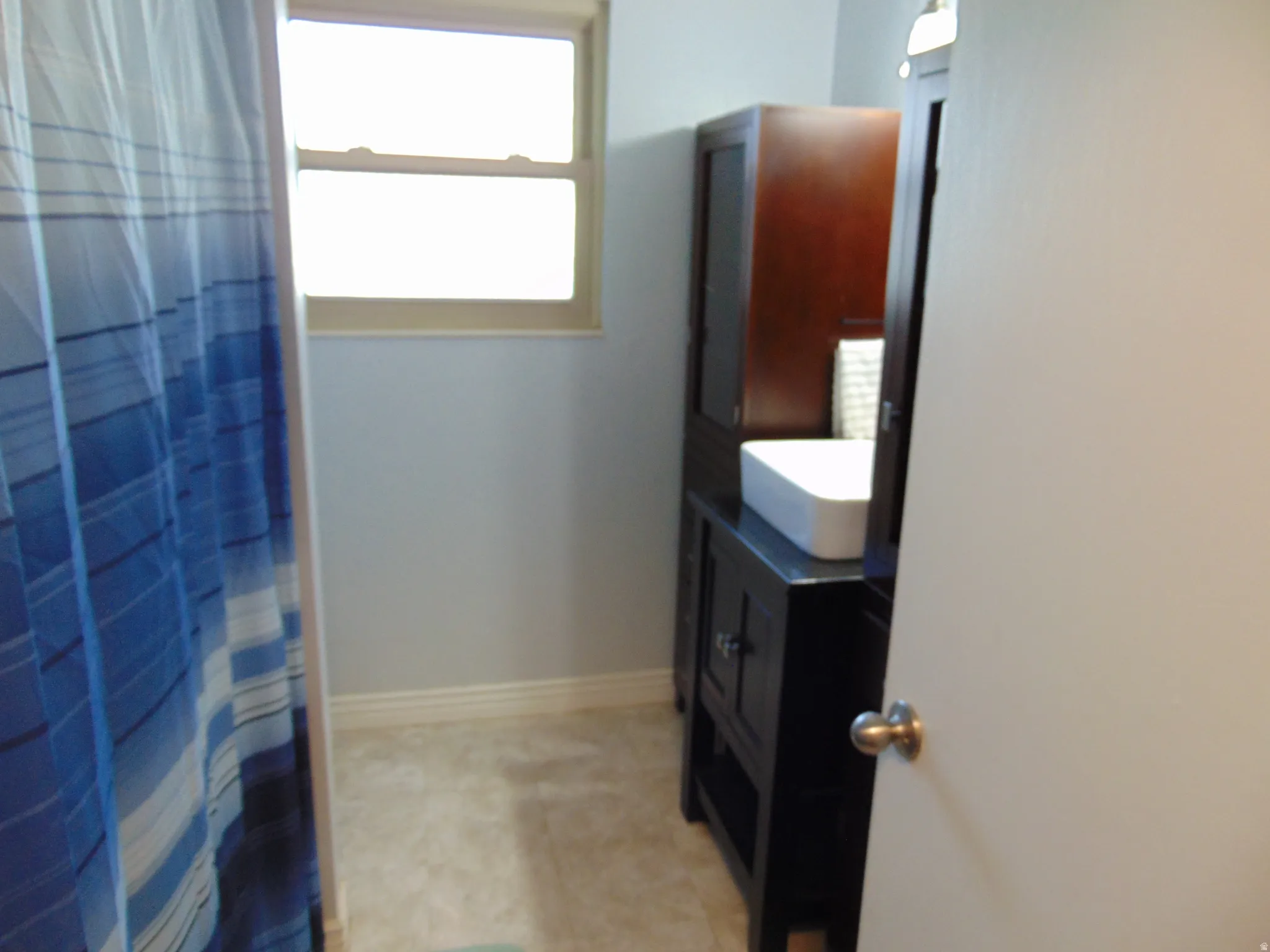 Bathroom with vanity and curtained shower