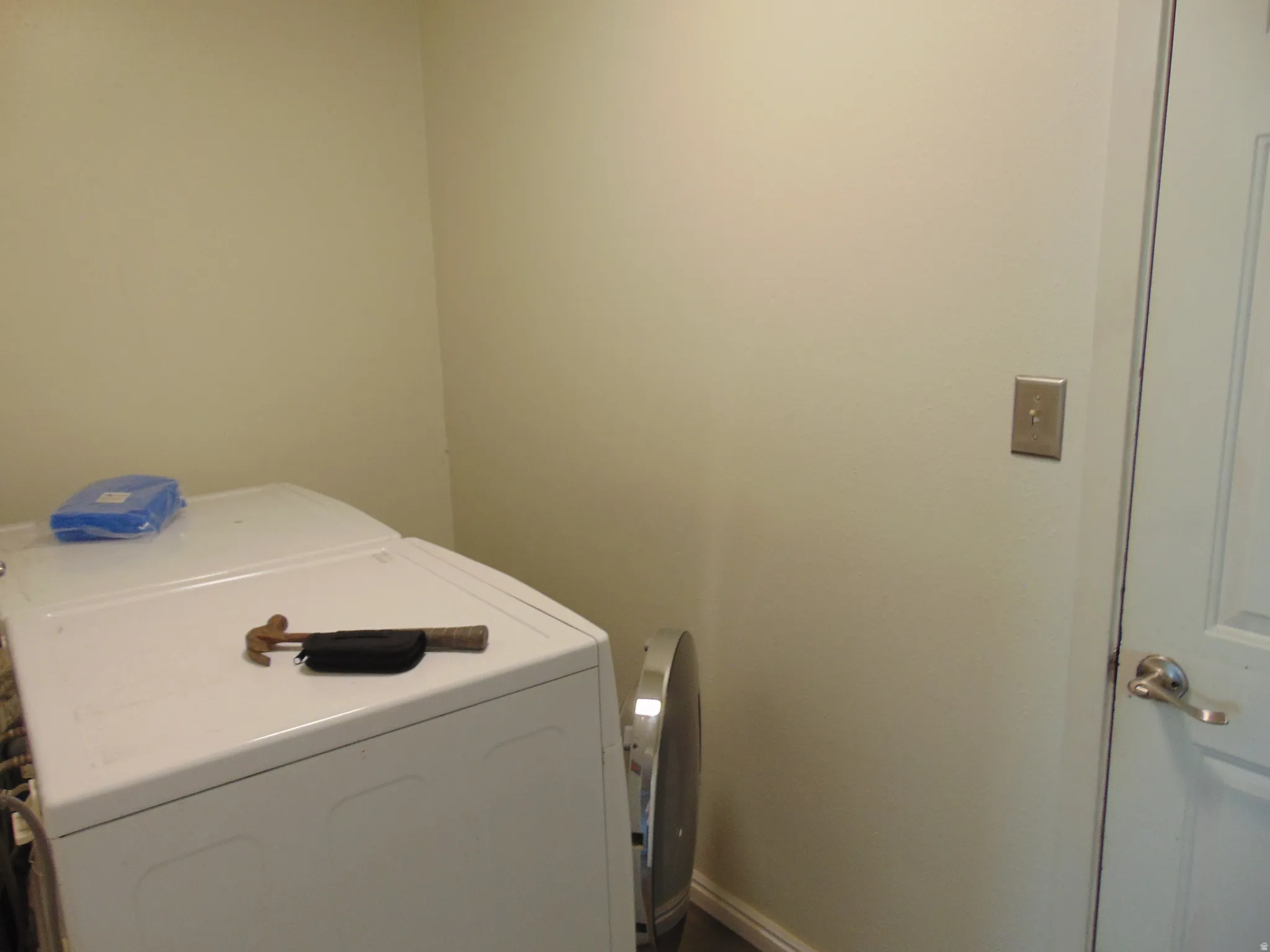 Laundry room featuring separate washer and dryer and baseboards