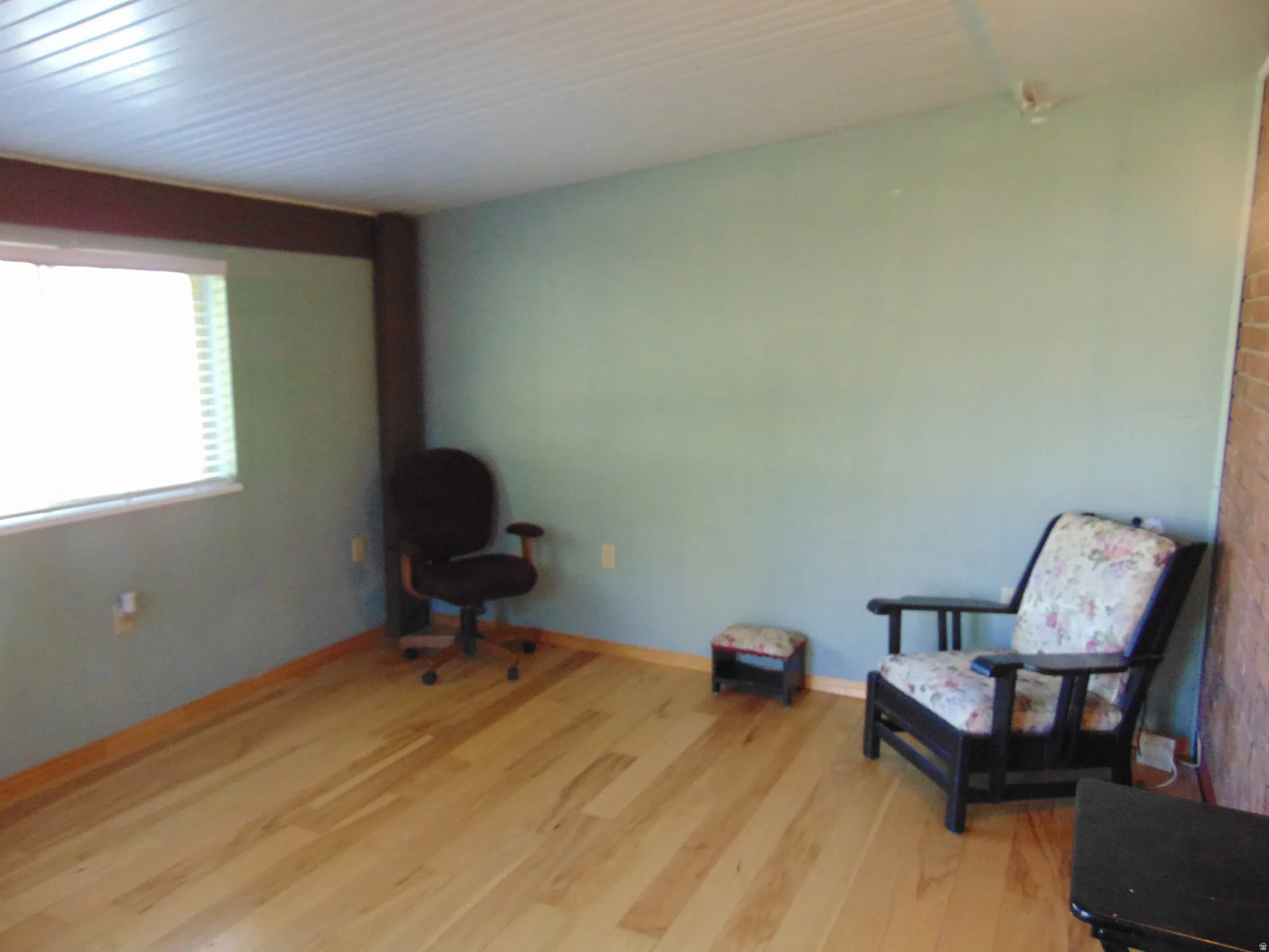 Living area with light wood finished floors and baseboards