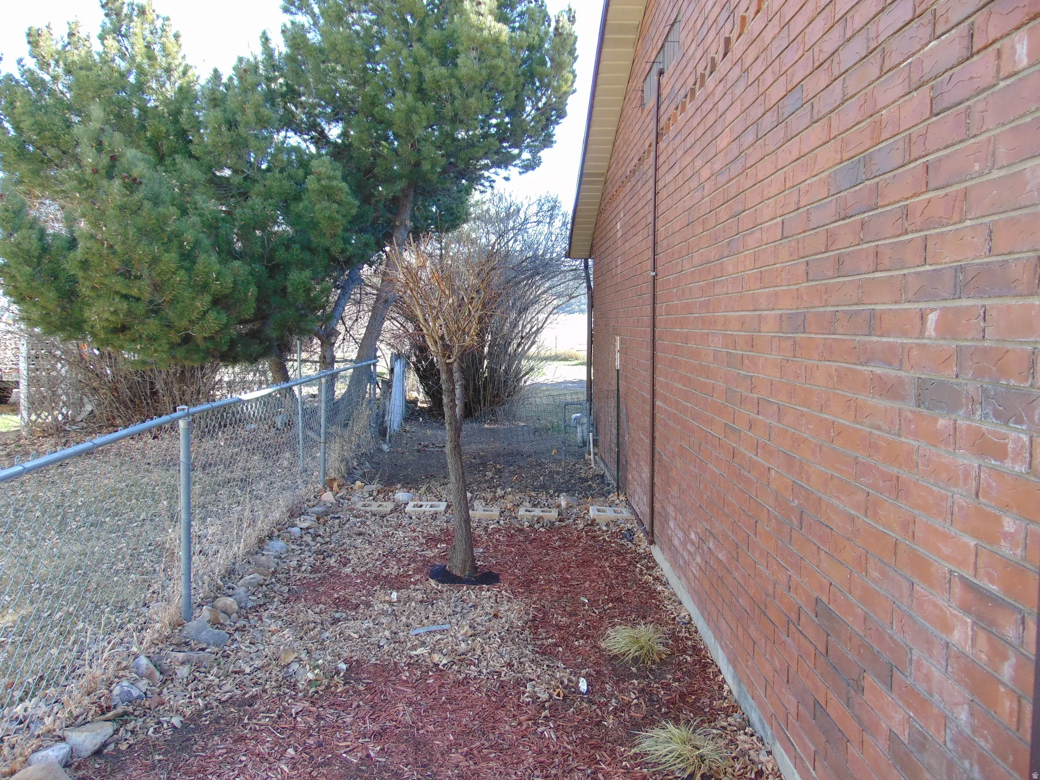 View of side of property featuring brick siding