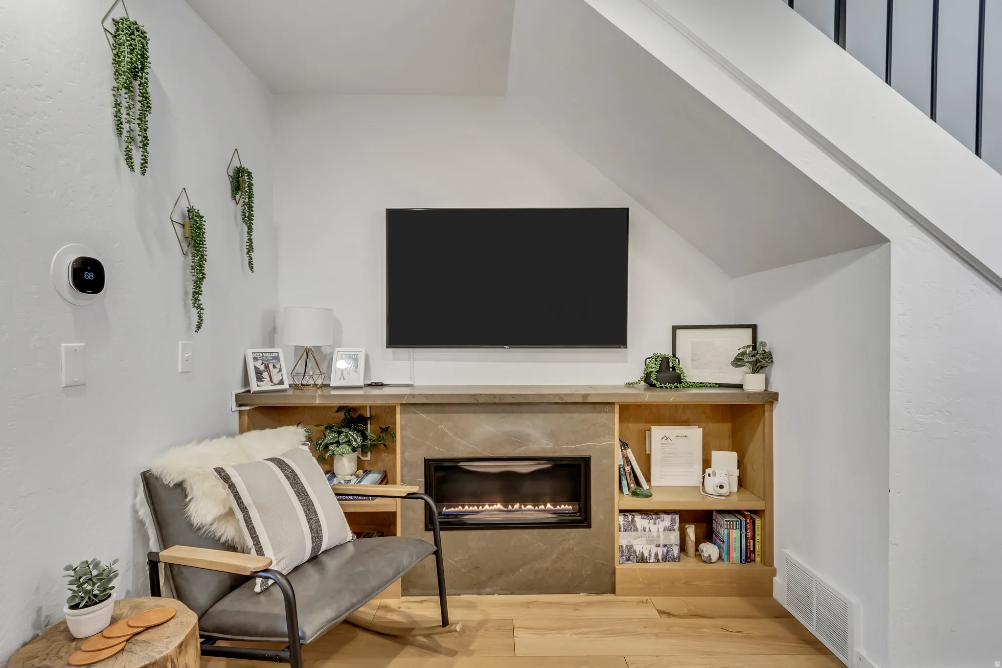 Living area featuring a premium fireplace and light wood-style floors