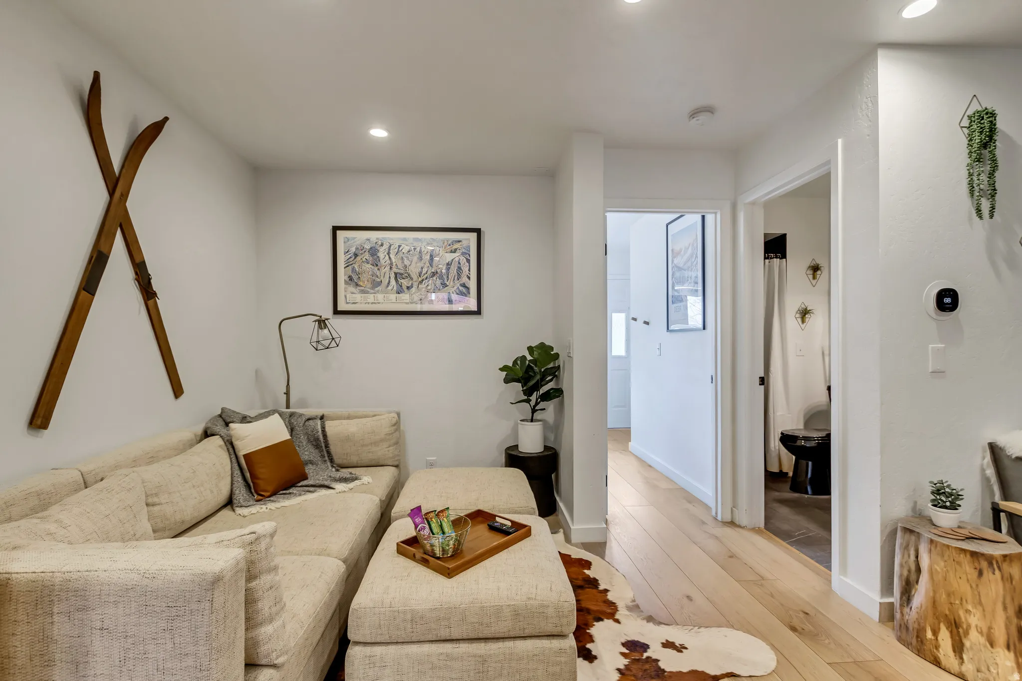 Living room with light wood-style floors and recessed lighting