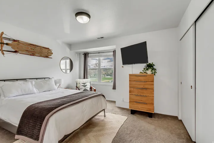 Bedroom featuring light colored carpet and a closet