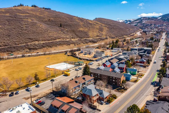 Aerial view of property and surrounding area with a mountainous background