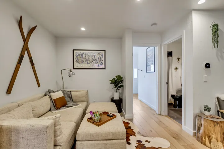 Living room with light wood-style floors and recessed lighting
