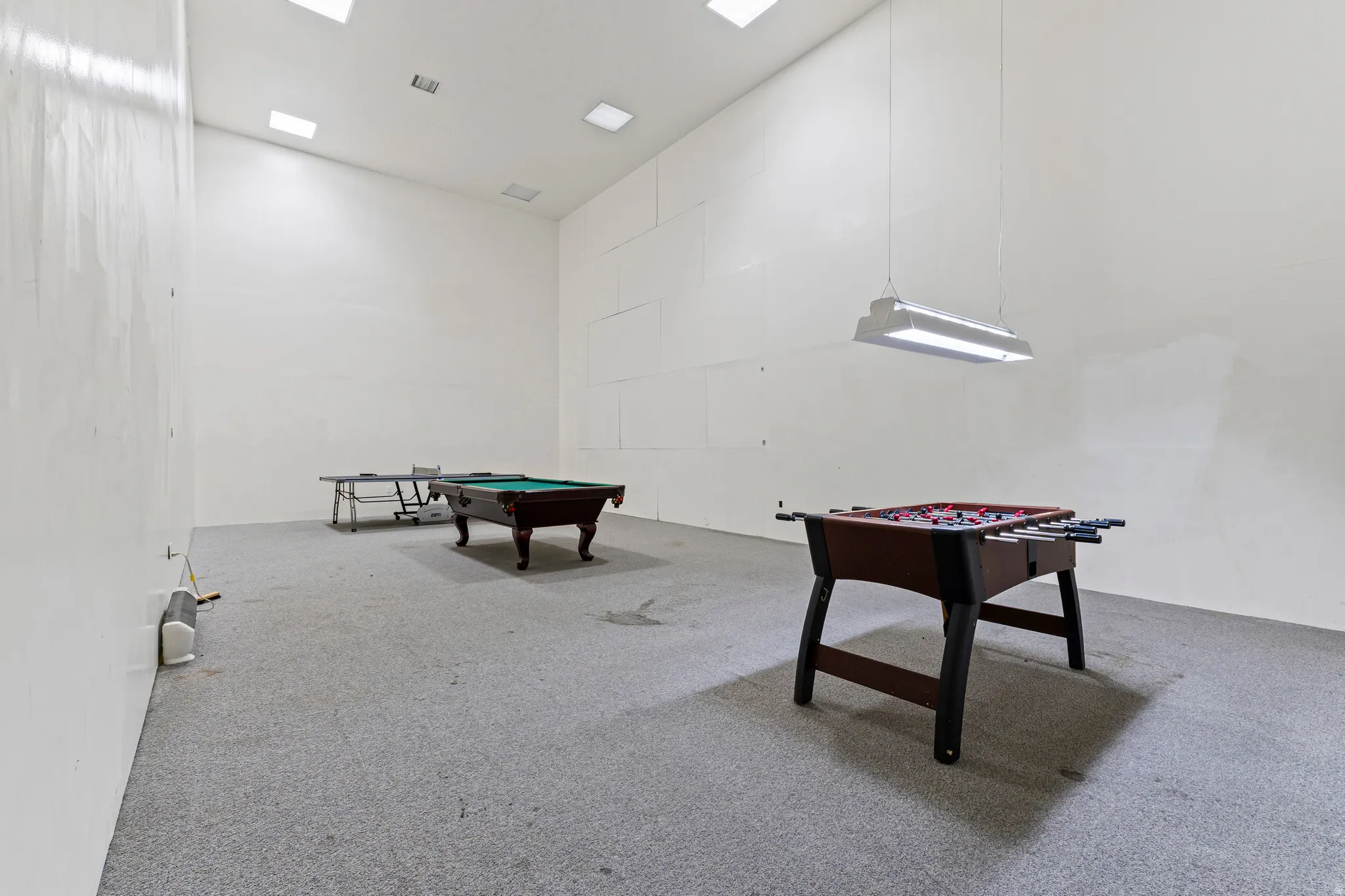 Rec room with a high ceiling and billiards