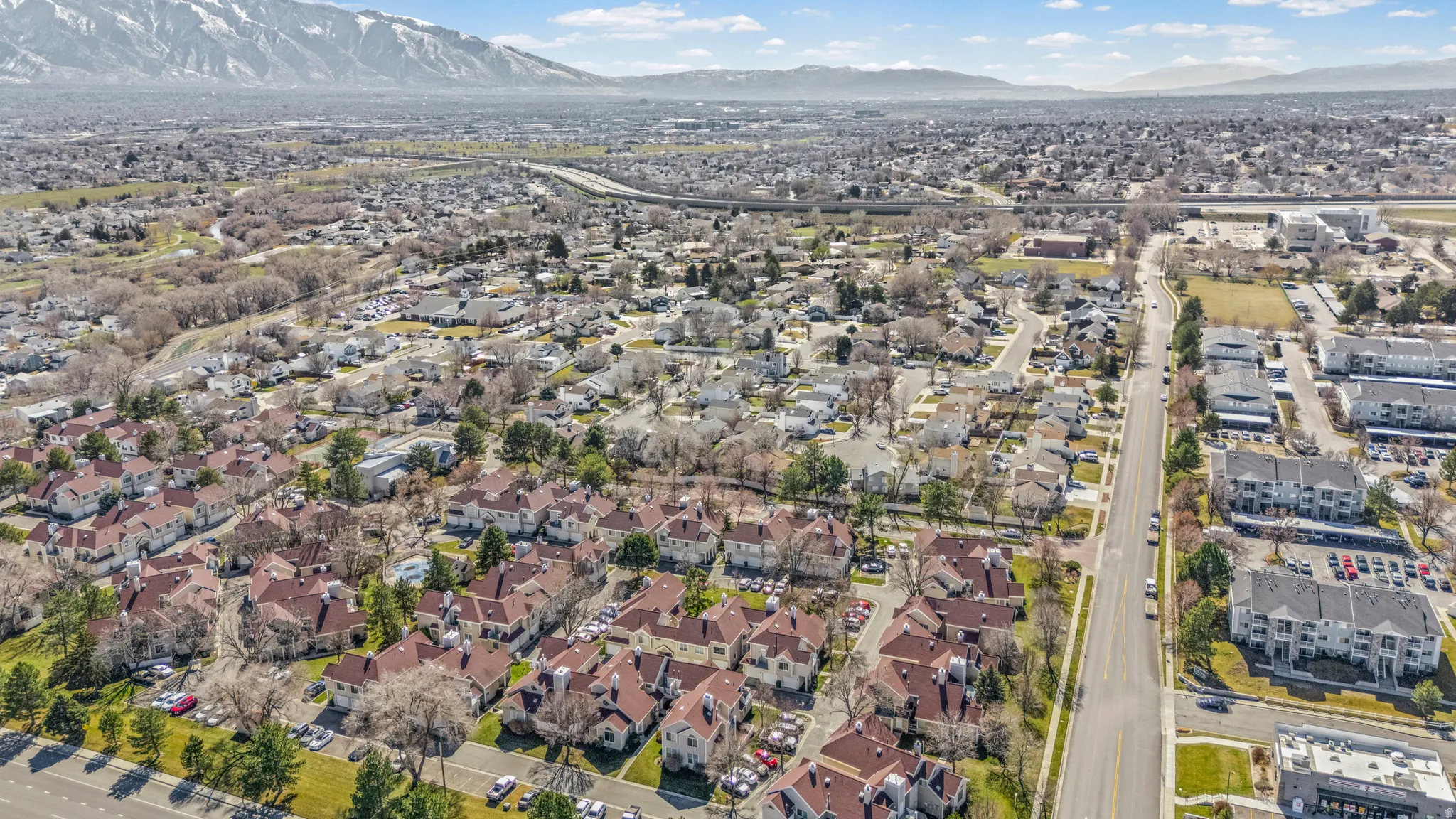 Aerial overview of property's location featuring a mountainous background and nearby suburban area
