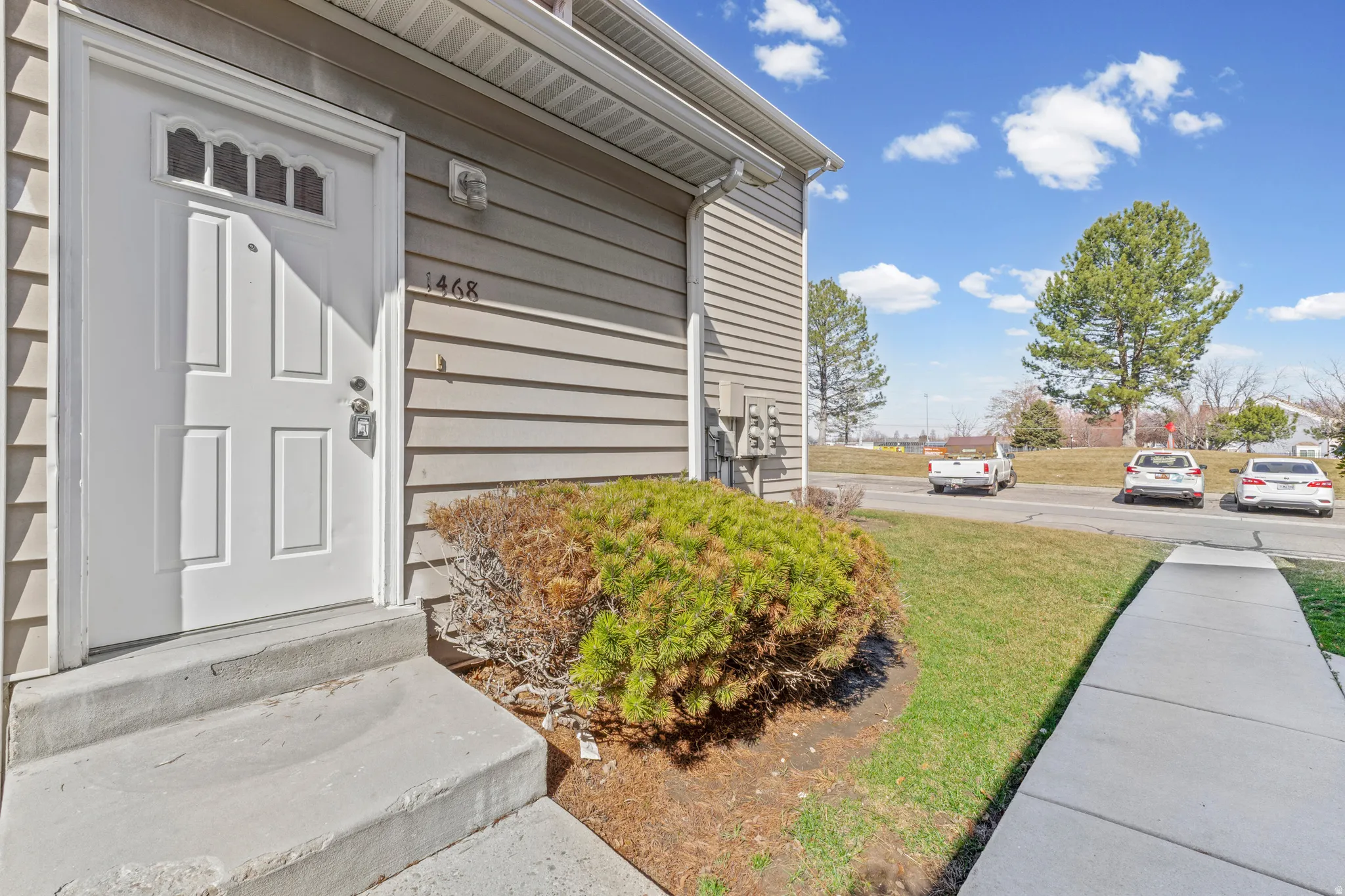 View of exterior entry with a lawn