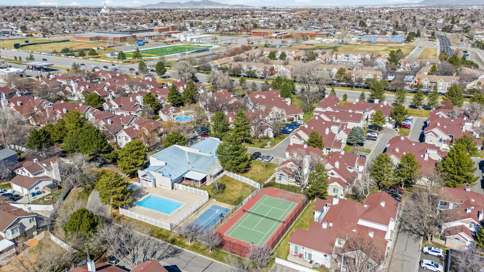 Aerial view of property and surrounding area with nearby suburban area