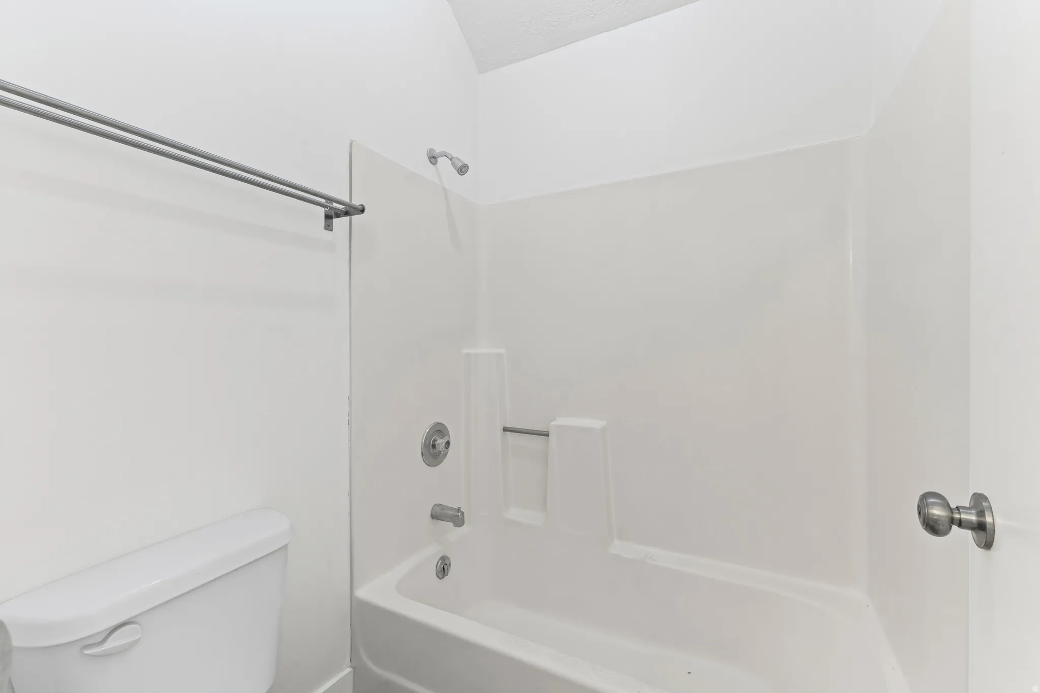 Full bathroom featuring toilet and  shower combination